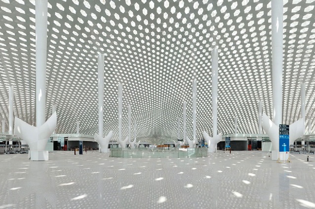 The distinctive white conical columns rise to touch the roof at a cathedral-like scale.