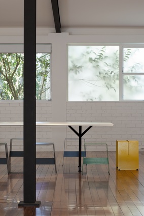 Dining table view to kitchen and work stations.
