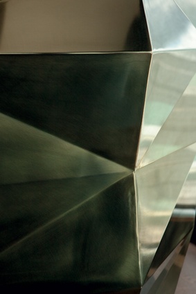 The reflecting patterns of the faceted-brass-plate bar at The Sugar Club.