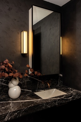 While all apartment bathrooms feature framed, fluted-glass bathroom partitions, the rest of the space was tailored to the individual buyers.