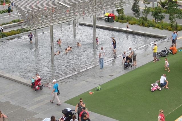 Children enjoy the <em>Wind Tree Sculpture</em> water feature in summer.