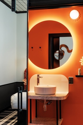 Custom-designed vanities were manufactured by Dalma. The bathroom and bedroom lights are also a custom design: a nod to the Edwardian garden and the People’s Palace logo on the hotel’s façade.