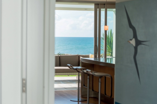 Rather than present the view in one hit, the architect has set up an experiential journey from the entry through to the living area.